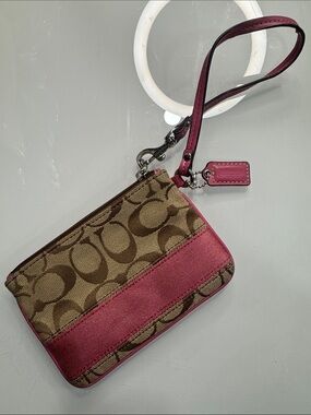 Coach signature wristlet with pink accents and hangtag
